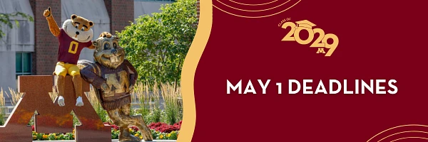 Goldy Gopher mascot poses with a statue